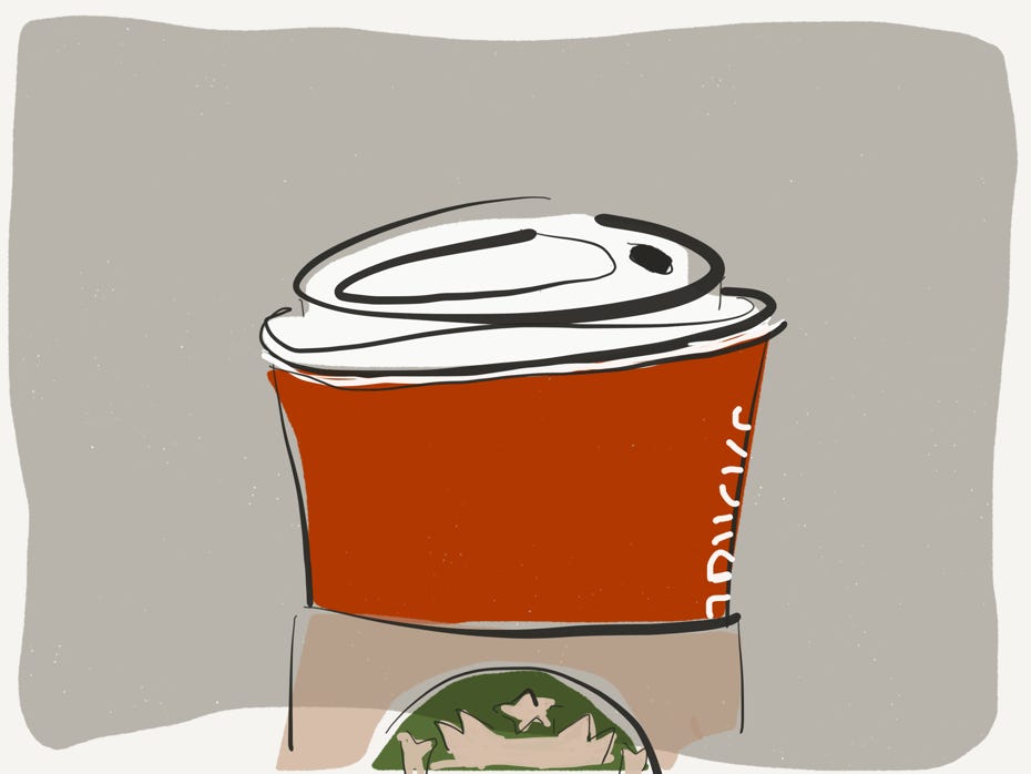 Zeigt eine Starbucks-Papppecher in der roten Weihnachtsedition